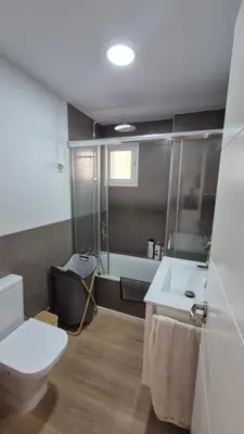 a bathroom with a toilet and a sink and a tub at Apartamento Colegueo in Sanlúcar de Barrameda