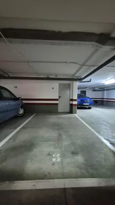 a parking garage with two cars parked in it at Apartamento Colegueo in Sanlúcar de Barrameda
