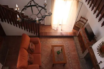 a living room with a couch and a window at Chalet con piscina privada en Conil in Cádiz