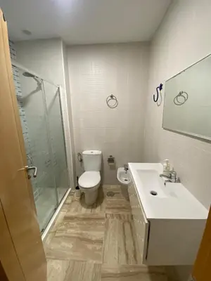 a bedroom with a bed with two pillows on it at Apartamento LA CARRAJOLILLA in Chiclana de la Frontera