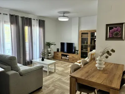 a living room with a couch and a table at Apartamento LA CARRAJOLILLA in Chiclana de la Frontera