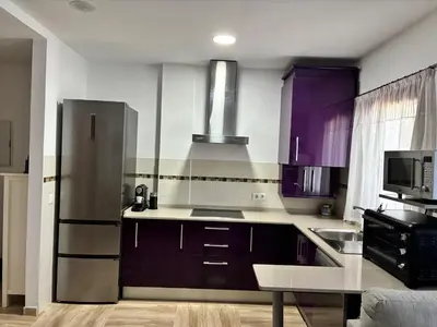 two beds in a room with a window at Apartamento LA CARRAJOLILLA in Chiclana de la Frontera