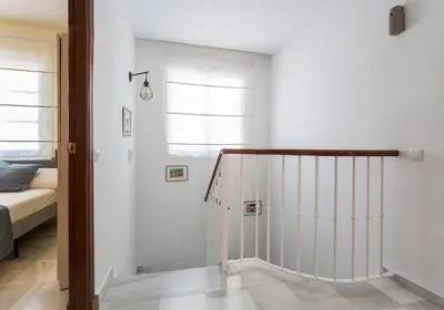 a room with a staircase with a bed and a window at Playa de fuentebravía in El Puerto de Santa María