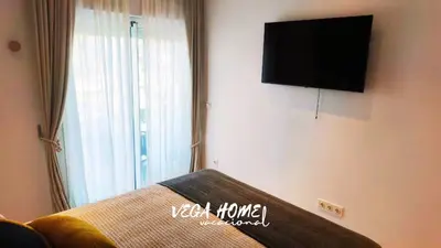 a living room with a tv and a couch and a window at Apartamento Eleven View Costa ballena MOON BLACK in Costa Ballena