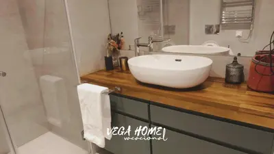 a bathroom with a white sink on a wooden counter at Apartamento Eleven View Costa ballena MOON BLACK in Costa Ballena