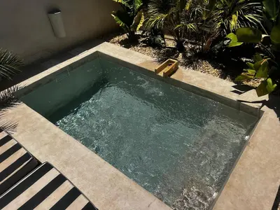 a small swimming pool with a bench next to it at Luxury Beach Front Boutique Hideaway with Pool - Casita Mas Tranquila in Conil de la Frontera
