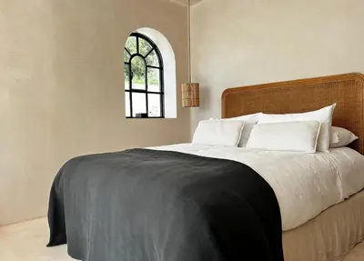 a bedroom with a large bed with a window at Luxury Beach Front Boutique Hideaway with Pool - Casita Mas Tranquila in Conil de la Frontera