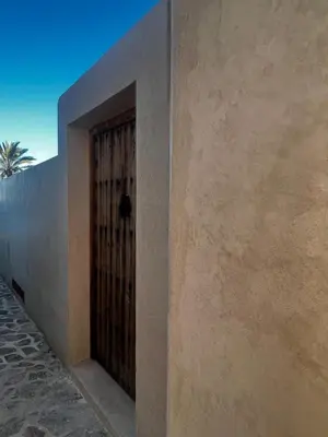 a door on the side of a building with a fence at Luxury Beach Front Boutique Hideaway with Pool - Casita Mas Tranquila in Conil de la Frontera