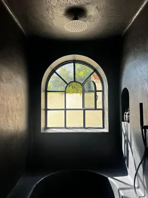 a window in a dark room with a view of a yard at Luxury Beach Front Boutique Hideaway with Pool - Casita Mas Tranquila in Conil de la Frontera