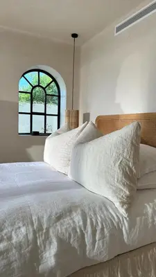 a bedroom with a white bed with a window at Luxury Beach Front Boutique Hideaway with Pool - Casita Mas Tranquila in Conil de la Frontera