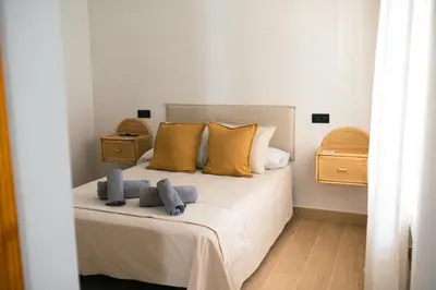 a bedroom with a bed with two towels on it at El Olivar de Baro in Jerez de la Frontera