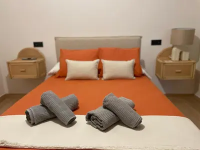 a bed with two rolled up towels on it at El Olivar de Baro in Jerez de la Frontera