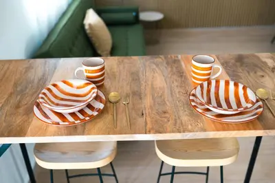 a wooden table with two cakes and cups on it at El Olivar de Baro in Jerez de la Frontera