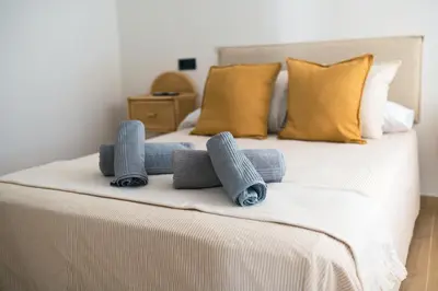a bed with three rolled up towels on it at El Olivar de Baro in Jerez de la Frontera
