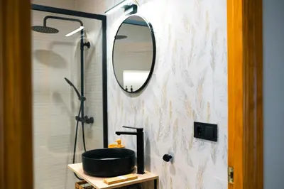 a bathroom with a sink and a mirror at El Olivar de Baro in Jerez de la Frontera