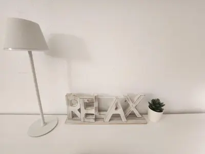 a desk with a lamp and a sign that says xax at Casa Las Piletas in Sanlúcar de Barrameda
