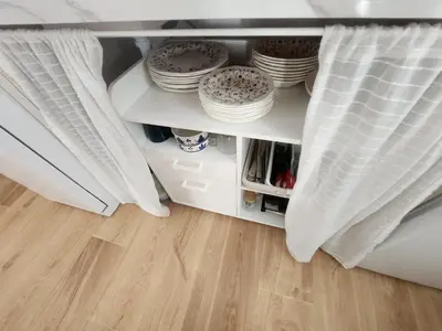 a cupboard with plates and dishes in a bedroom at Casa Las Piletas in Sanlúcar de Barrameda