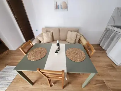 a table and chairs in a living room with a couch at Casa Las Piletas in Sanlúcar de Barrameda