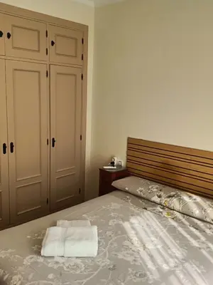 a bedroom with a bed with two towels on it at Casa Villa Lydia en el centro de Chipiona in Chipiona