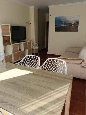 a living room with a couch and a table and chairs at Casa Villa Lydia en el centro de Chipiona in Chipiona