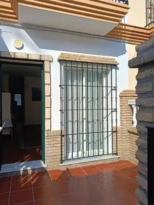 a gate on the side of a house at Casa Villa Lydia en el centro de Chipiona in Chipiona