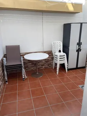 a room with two chairs and a table and chairs at Casa Villa Lydia en el centro de Chipiona in Chipiona
