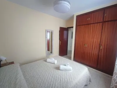 a bedroom with a bed with two towels on it at Apartamento Plaza Alta in Sanlúcar de Barrameda