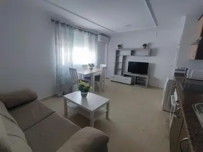 a living room with a couch and a table at Apartamento Plaza Alta in Sanlúcar de Barrameda