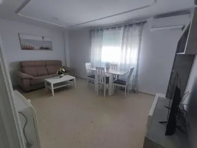 a living room with a couch and a table at Apartamento Plaza Alta in Sanlúcar de Barrameda