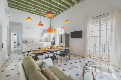 a kitchen and living room with a table and chairs at Cadizz- Andalusian Green Palace - ideal familias centro del Puerto Santa María in El Puerto de Santa María