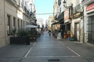 a person walking down a street in a city at Cadizz- Andalusian Green Palace - ideal familias centro del Puerto Santa María in El Puerto de Santa María