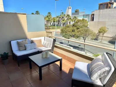 a balcony with two couches and a coffee table at Apartment with terrace Jerez Norte Hipercor in Jerez de la Frontera