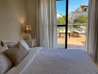 a bedroom with a bed and a view of a patio at Apartment with terrace Jerez Norte Hipercor in Jerez de la Frontera