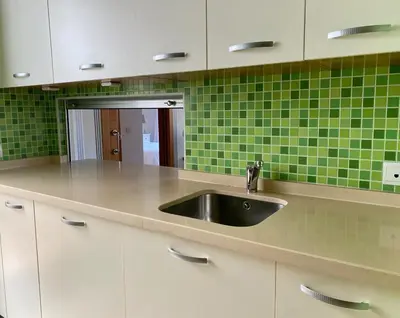 a kitchen with a sink and green tiles at Apartment with terrace Jerez Norte Hipercor in Jerez de la Frontera