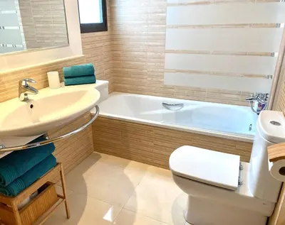 a bathroom with a sink and a toilet and a tub at Apartment with terrace Jerez Norte Hipercor in Jerez de la Frontera