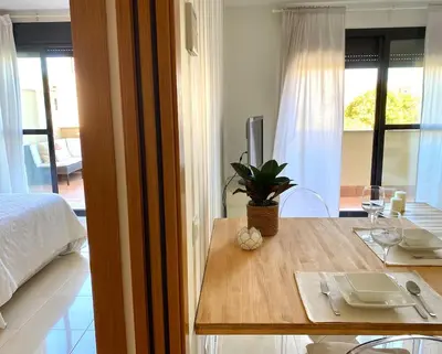 a room with a table and a bed and a table with wine glasses at Apartment with terrace Jerez Norte Hipercor in Jerez de la Frontera