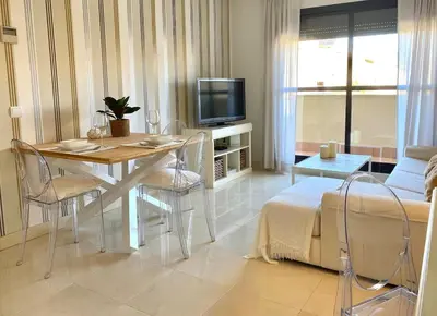 a living room with a dining table and a television at Apartment with terrace Jerez Norte Hipercor in Jerez de la Frontera