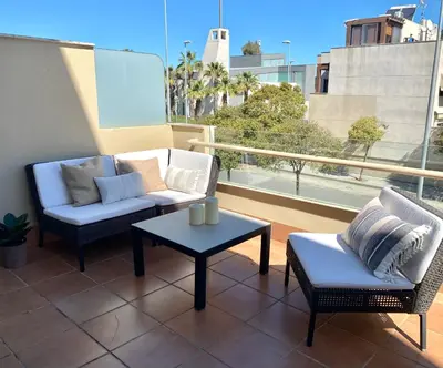 a patio with two chairs and a table on a balcony at Apartment with terrace Jerez Norte Hipercor in Jerez de la Frontera