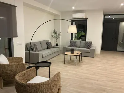 a living room with couches and chairs and a table at Esmeralda Sea Villa - Beach&Golf Sancti Petri in Novo Sancti Petri