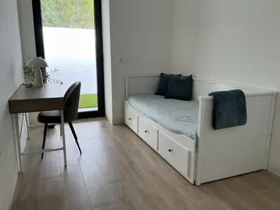 a bedroom with a bed and a desk and a window at Esmeralda Sea Villa - Beach&Golf Sancti Petri in Novo Sancti Petri