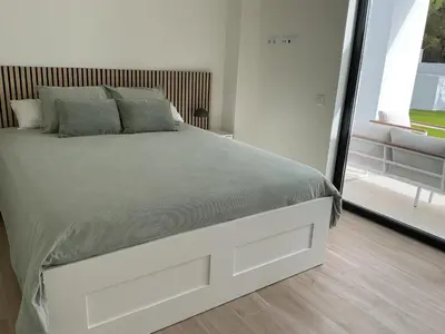 a white bed in a bedroom with a window at Esmeralda Sea Villa - Beach&Golf Sancti Petri in Novo Sancti Petri