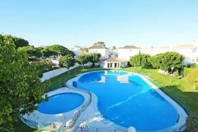 an overhead view of a large blue swimming pool at Pinar de la Almadraba, Apartamentos Living Sur in Rota
