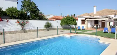 a swimming pool in front of a house at Casa Rocio 1 in Conil de la Frontera