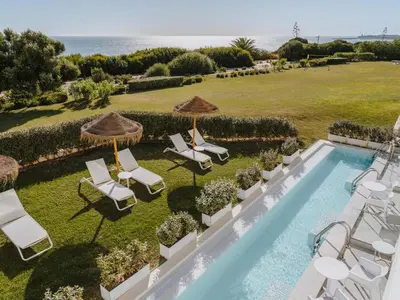an aerial view of a villa with a swimming pool and lawn at Grupotel Conil Playa - Adults Only Recommended in Conil de la Frontera