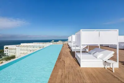 a swimming pool on the roof of a building at Grupotel Conil Playa - Adults Only Recommended in Conil de la Frontera