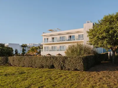a building with a hedge in front of it at Grupotel Conil Playa - Adults Only Recommended in Conil de la Frontera