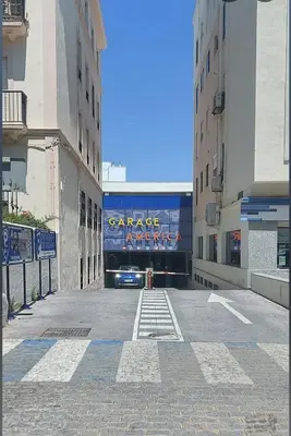 an empty street with a car in a tunnel at Apartamento Hibiscos Little Apartments in Cádiz