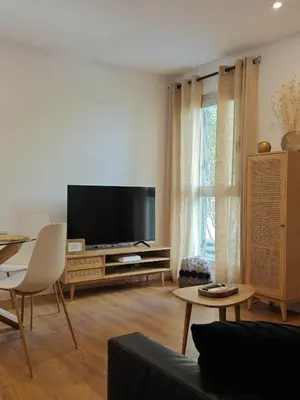 a living room with a large flat screen tv at Apartamento Hibiscos Little Apartments in Cádiz