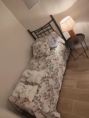 a small bed in a room with a lamp at Maktub Medina in Medina Sidonia