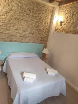 a bedroom with a white bed with towels on it at Maktub Medina in Medina Sidonia